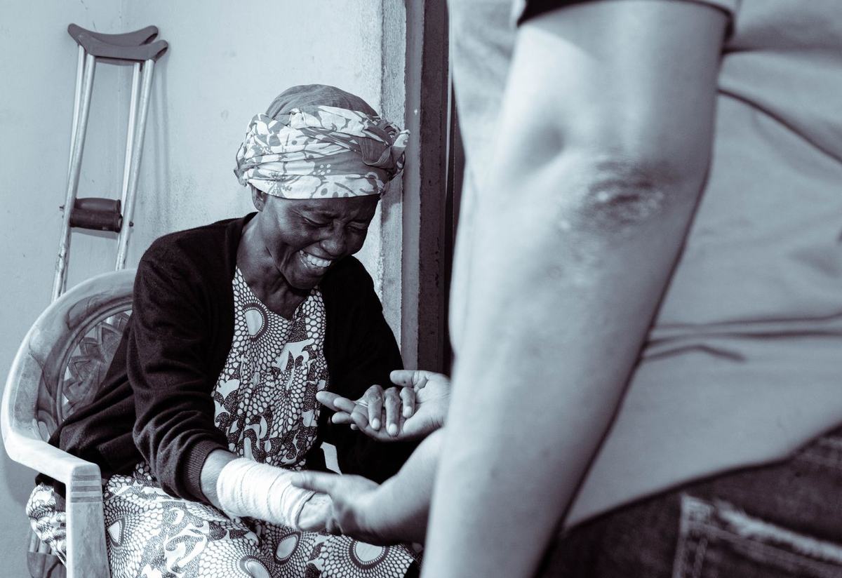 A patient shares a smile during palliative care in Cameroon.