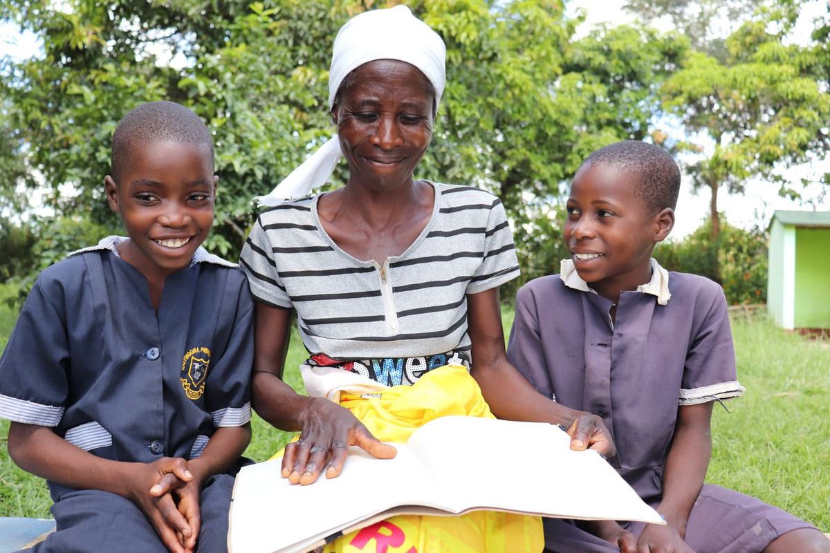 A mother and her children revisit notes after a childhood cancer awareness session.