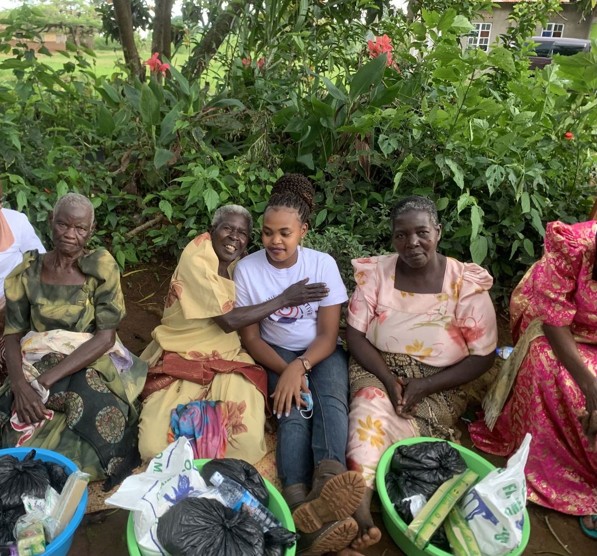 Older people gather in Katosi to receive essential supplies from the palliative care team.