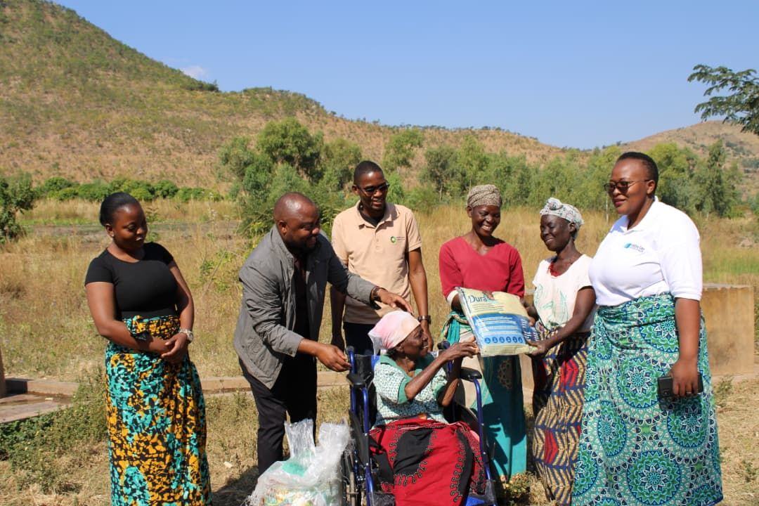 A woman and her family receive a wheelchair and mosquito net through coordinated community support.